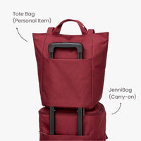 Stack of two red bags with labels: one tote bag and one carry-on bag.