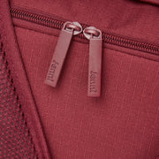 Close-up of a zipper pull on a red bag.