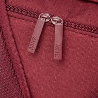 Close-up of a zipper pull on a red bag.