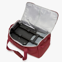 Red bag with open compartment showing black interior and red handle.