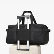 Black duffel bag with wheels on a white background